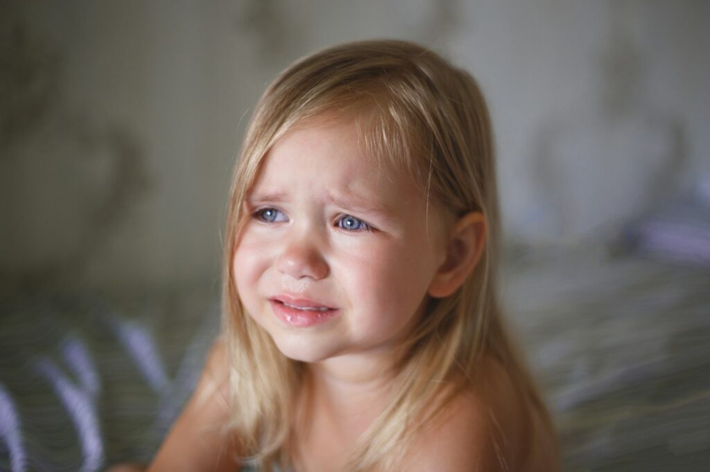 portrait of a beautiful little crying girl